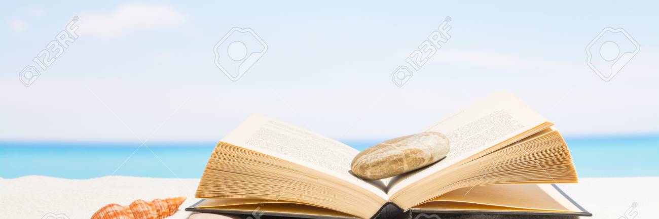 Book on the beach with white sand. Background for banner